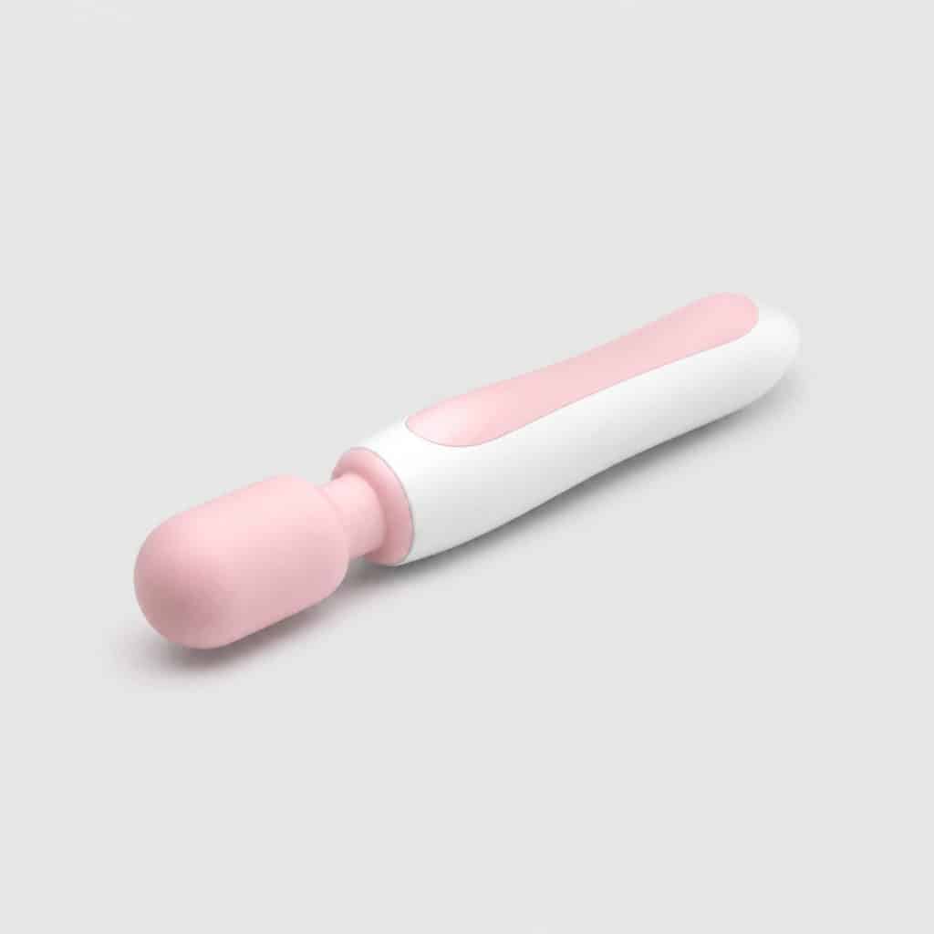 Sonde ergonomique blanche et rose pâle posée seule sur fond neutre