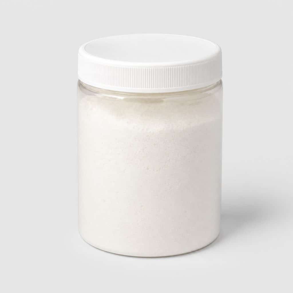 Pot de peptides de collagène en poudre neutre posé sur fond clair